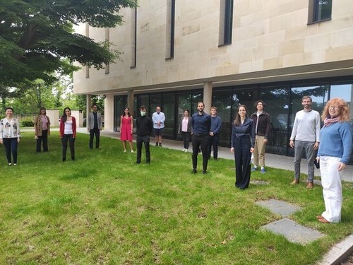 A group of people standing on the grass outside the Laidlaw Music Centre